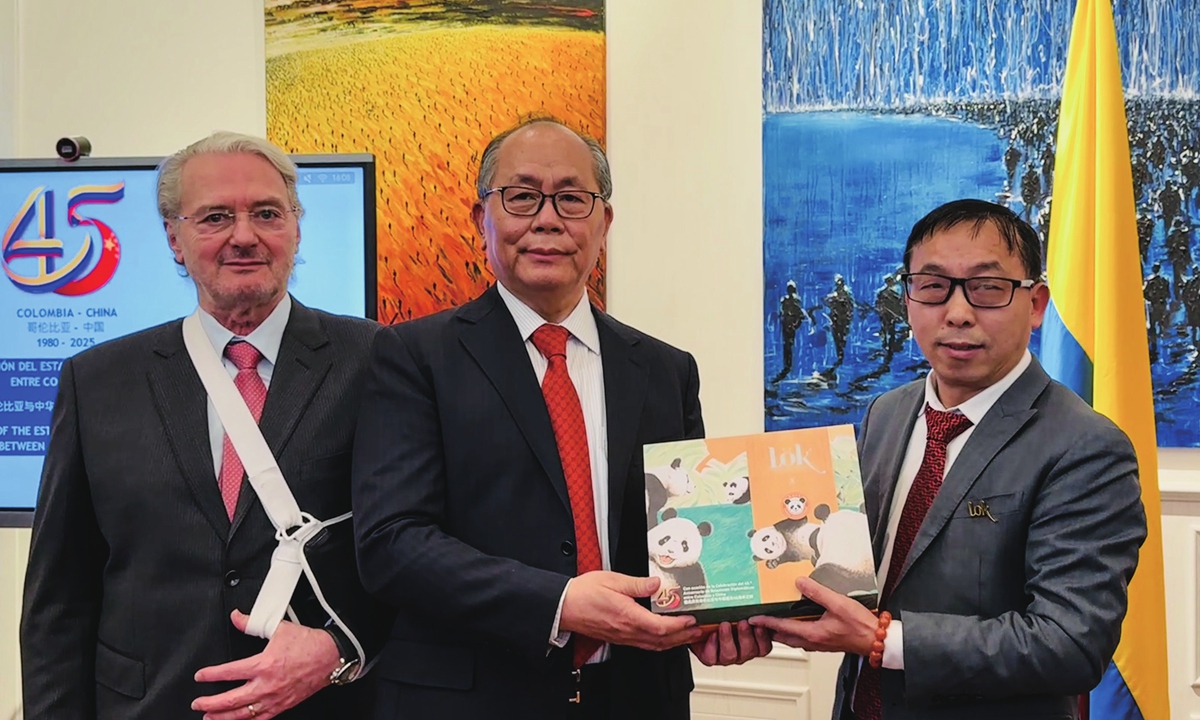 Colombian Ambassador to China Sergio Cabrera Cárdenas (left), Special Representative of the Chinese Government on Latin American Affairs Qiu Xiaoqi (center), and a delegate from an enterprise pose for a picture in Beijing, on February 7, 2025. Photo: Courtesy of the Embassy of Colombia in China