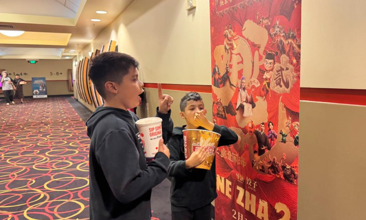 Children look at a poster for Ne Zha 2 in a theater in Los Angeles County, the United States, Feb. 14, 2025. Chinese box office hit Ne Zha 2 was screened on Friday in a limited theatrical release in North America. The highly-anticipated film is being released by CMC Pictures in Mandarin with English subtitles in about 750 selected theaters in North American cities including Los Angeles, San Francisco, Houston, Chicago, New York, Boston, Atlanta, Toronto, Vancouver and a few other cities with a large overseas Chinese population. (Photo by Qiu Chen/Xinhua)
