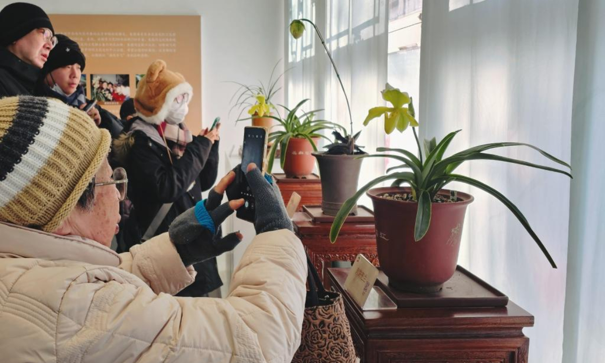 Visitors take photo of flowers during an orchids exhibition at Zhongshan Park in Beijing, capital of China, Jan. 30, 2025. (Xinhua)