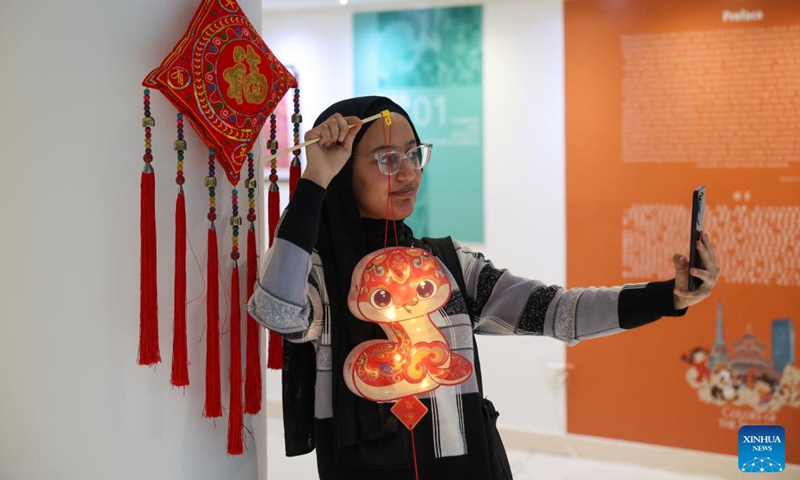 A Moroccan woman takes a selfie with a snake-shaped lantern at a Lantern Festival celebration event in Rabat, Morocco, on Feb. 12, 2025. (Photo: Xinhua)