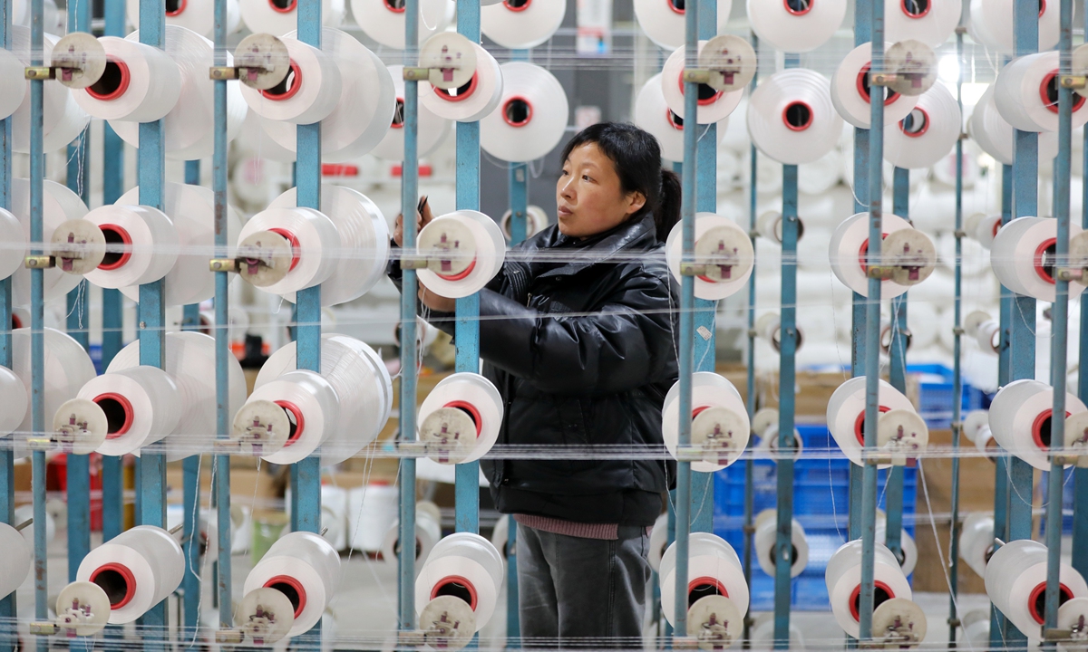 A worker checks the equipment at a textile workshop in Yangzhuang village, Huaibei, East China's Anhui Province, on February 14, 2025. Given the abundant local labor resources, the government of Huaibei introduced labor-intensive enterprises into rural areas, generating more job opportunities and optimizing employment. Photo: VCG