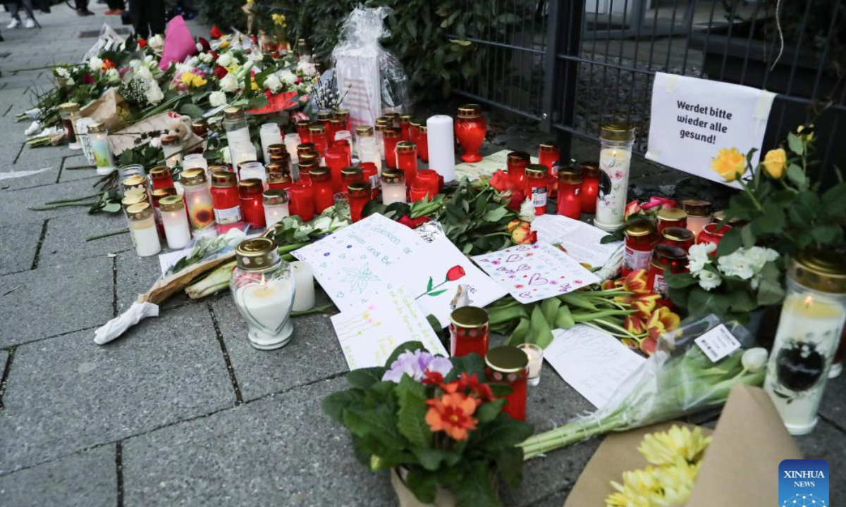 Flowers and candles are placed near the site of a car ramming in Munich, Germany, on Feb. 15, 2025. (Xinhua/Zhang Fan)