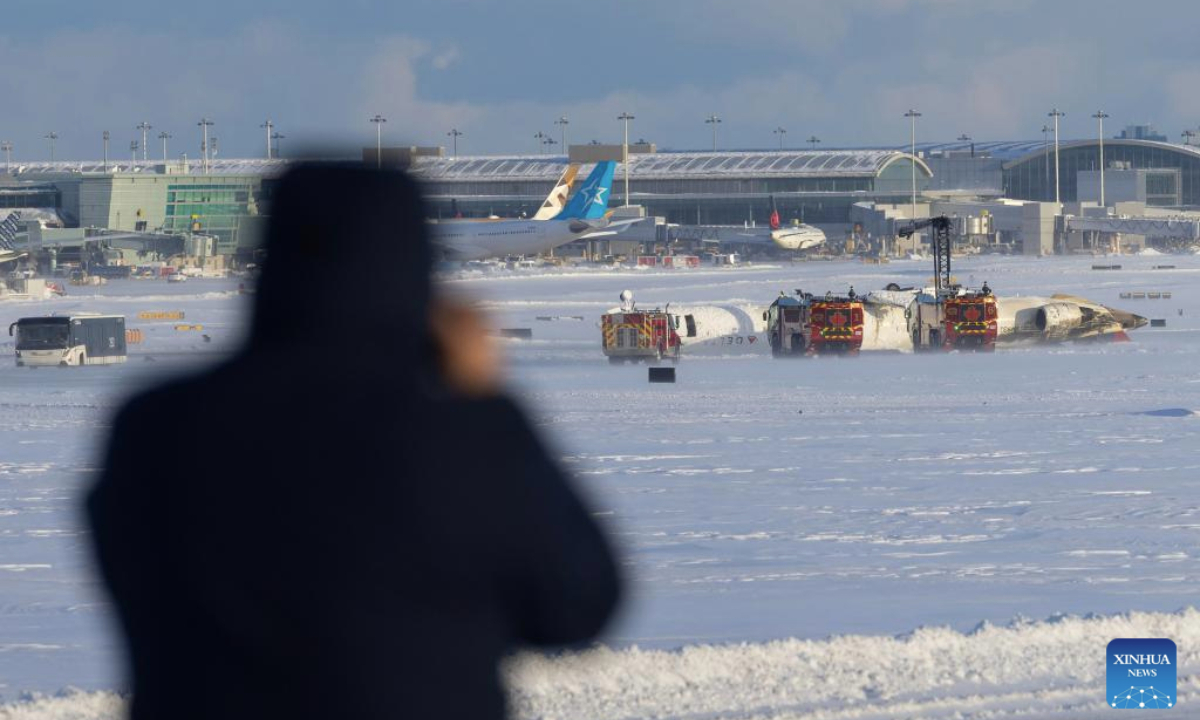 A Delta Air Lines plane is seen upside down after a crash at the Toronto Pearson International Airport in Mississauga, Canada, on Feb. 17, 2025. (Photo by Zou Zheng/Xinhua)