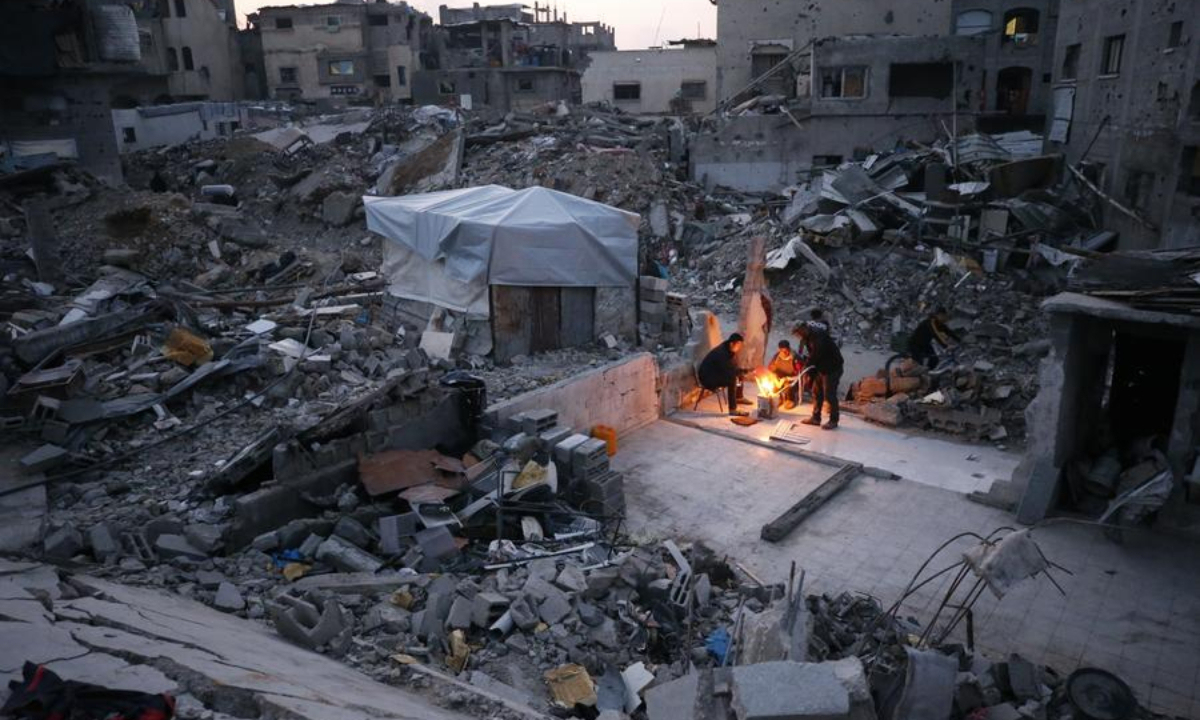 Palestinians are seen living among the rubble of destroyed houses in Jabalia in the northern Gaza Strip, Feb. 16, 2025. (Photo by Mahmoud Zaki/Xinhua)