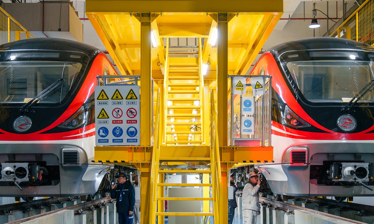 Maintenance staff inspect and clean parts of electric locomotives at a rail transit base in Jinhua, East China's Zhejiang Province on February 18, 2025. Official data showed that the number of urban rail transit train trips in China was 40.85 million, with a passenger volume of 32.24 billion in 2024. The annual passenger volume was up by 9.5 percent from 2023. Photo: VCG