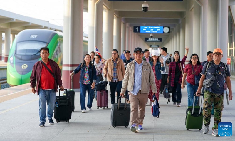 Tourists from Laos and Thailand arrive at the Xishuangbanna railway station in Jinghong City, Xishuangbanna Dai Autonomous Prefecture, southwest China's Yunnan Province, Feb. 18, 2025. After entering through Mohan Port, a tourist group of 15 people from Laos and Thailand took a train and arrived in Jinghong City, Xishuangbanna Dai Autonomous Prefecture on Tuesday. It was the first tourist group to arrive since the implementation of the visa-free policy allowing tourist groups from ASEAN (the Association of Southeast Asian Nations) countries to enter Xishuangbanna. (Photo: Xinhua)