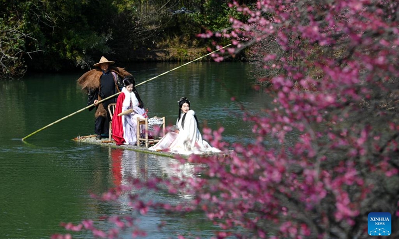 People in traditional costumes enjoy plum blossoms while riding a bamboo raft at the Xixi National Wetland Park in Hangzhou, east China's Zhejiang Province, Feb. 18, 2025. The Xixi wetland in Hangzhou has entered the best season for viewing plum blossoms. (Photo: Xinhua)
