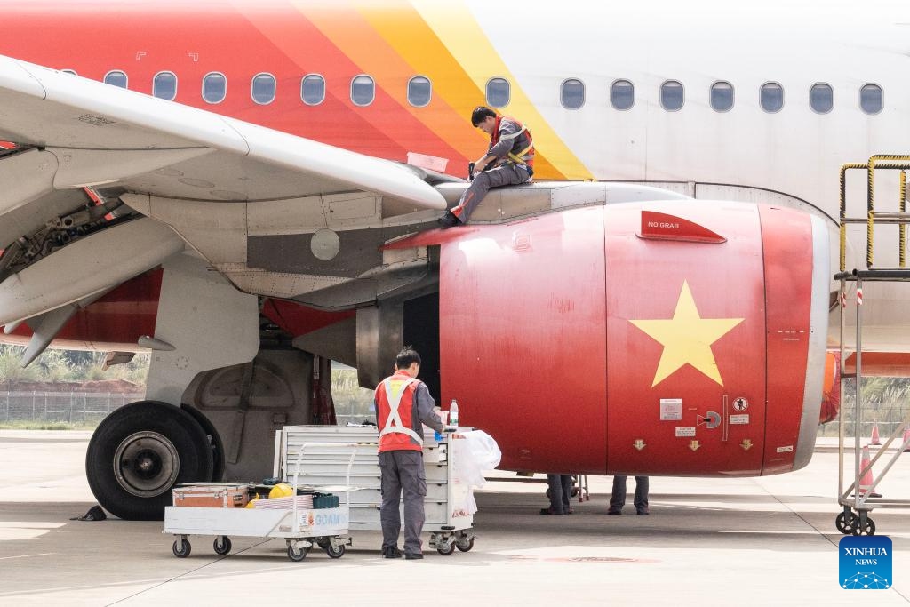 Staff members work on an inbound airplane at a one-stop aircraft maintenance base of Hainan Free Trade Port in Haikou, south China's Hainan Province, Feb. 17, 2025. Since the one-stop aircraft maintenance base of Hainan Free Trade Port was put into use in 2022, a total of 83 aircraft and 17 engines have been maintained and repaired in the bonded zone, with a total value of 45.05 billion yuan (about 6.2 billion U.S. dollars). (Photo: Xinhua)