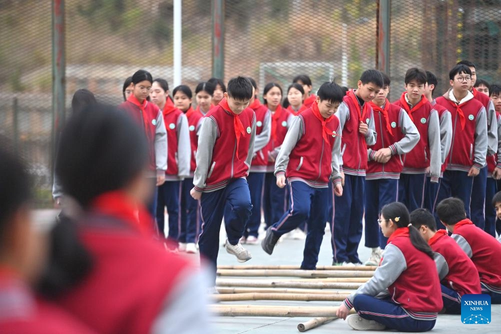 Students perform bamboo pole dance at a middle school in Wuzhou, south China's Guangxi Zhuang Autonomous Region, Feb. 17, 2025. With a mixture of nerves and excitement, many students in China attended their special first class of new semester. (Photo: Xinhua)