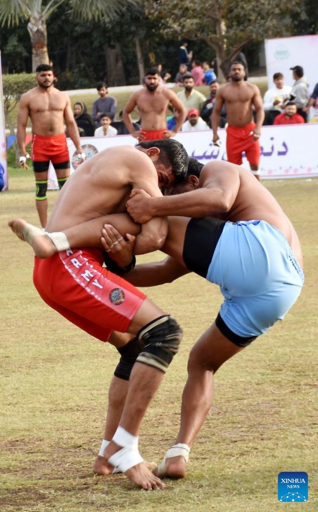 People compete in a Kushti match in Lahore, Pakistan, Feb. 18, 2025. Pehlwani wrestling, also known as Kushti, is a traditional competitive sport which was developed in the Mughal era. It is popular in South Asian countries. (Photo: Xinhua)