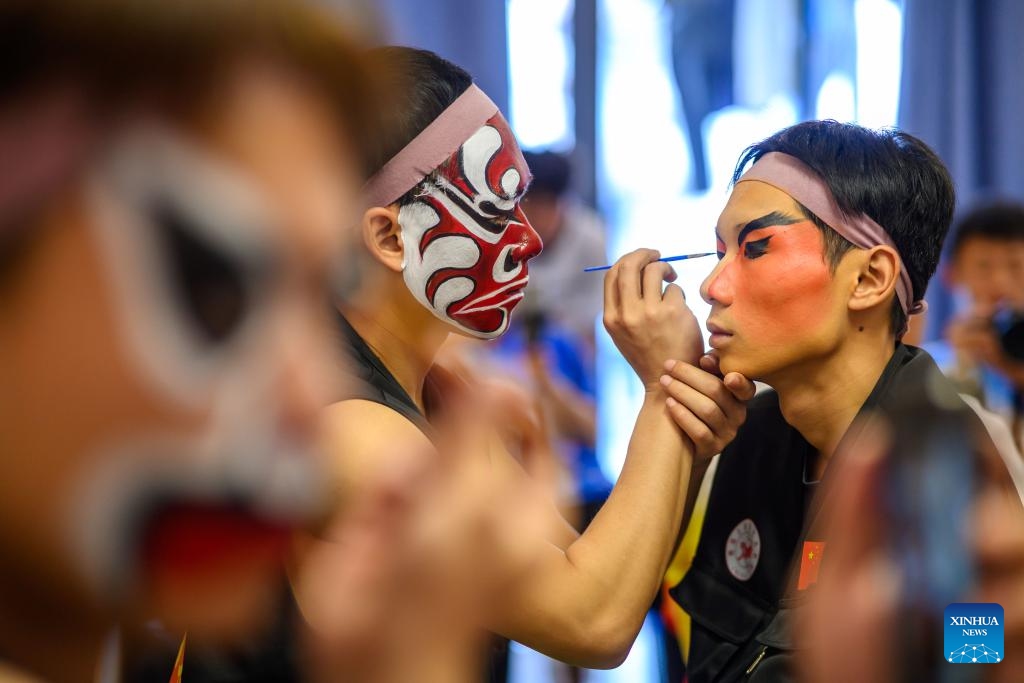 Members of a Yingge team from China put on makeup for performance in Johor, Malaysia, Feb. 18, 2025. Yingge teams from China and Malaysia staged Yingge dances during a parade here on Tuesday, attracting lots of audience on the spot. (Photo: Xinhua)