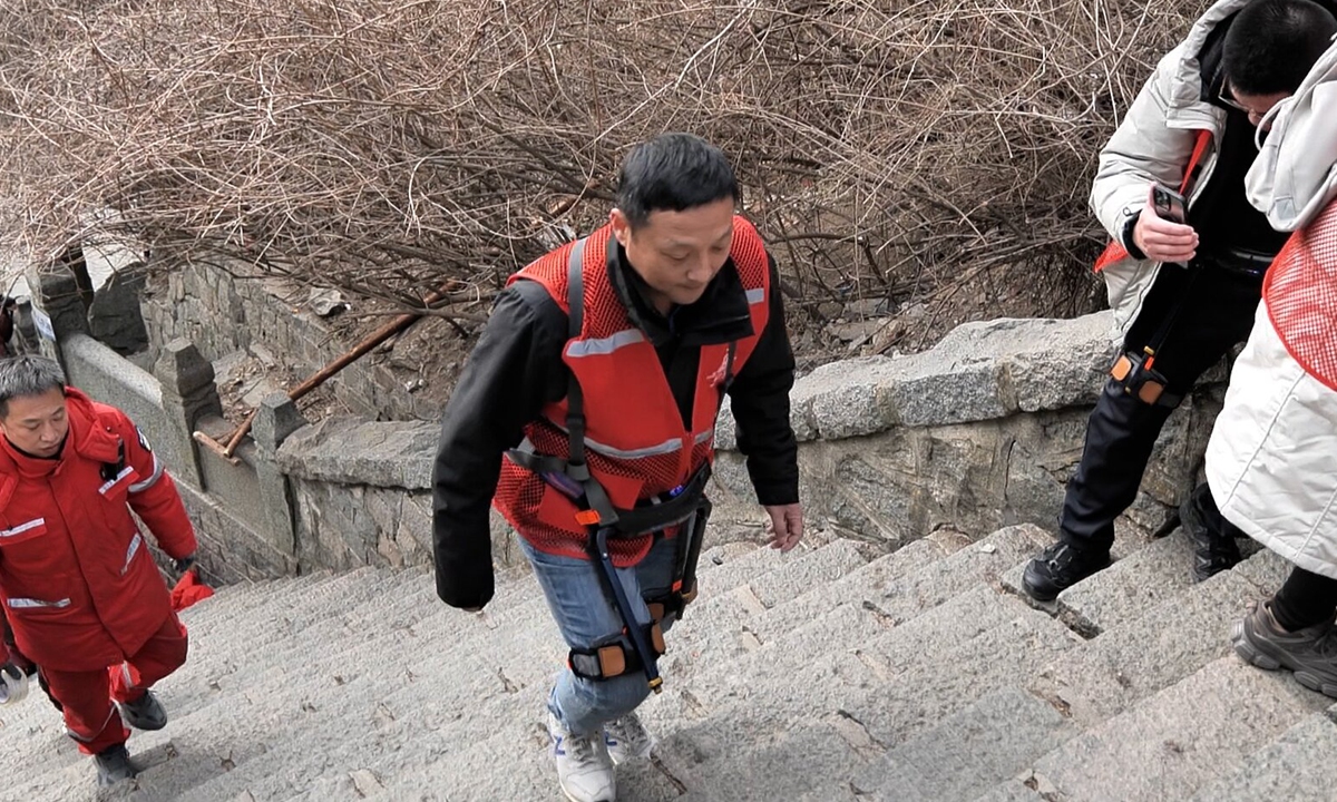 A man assisted by exoskeleton robot climbs Mount Tai in East China's Shandong Province. File photo: Courtesy of TCTG