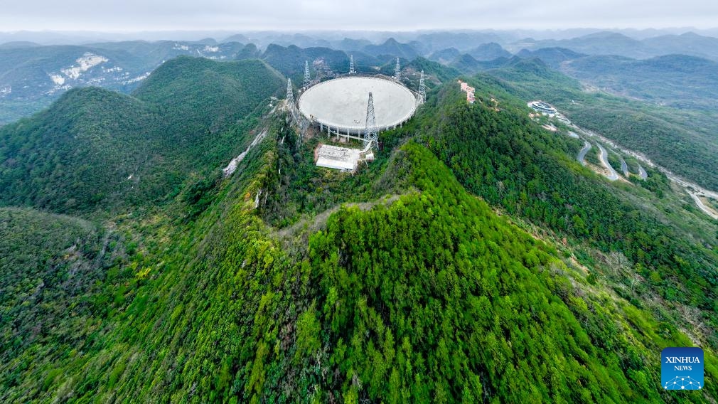 An aerial drone photo taken on Feb. 18, 2025 shows China's Five-hundred-meter Aperture Spherical Radio Telescope (FAST) under maintenance in southwest China's Guizhou Province. In recent years, Guizhou has leveraged its scientific research resources such as FAST to develop educational travel for science, a favorable choice across China for inquisitive minds seeking to embark on a journey of knowledge and exploration in science. (Photo: Xinhua)