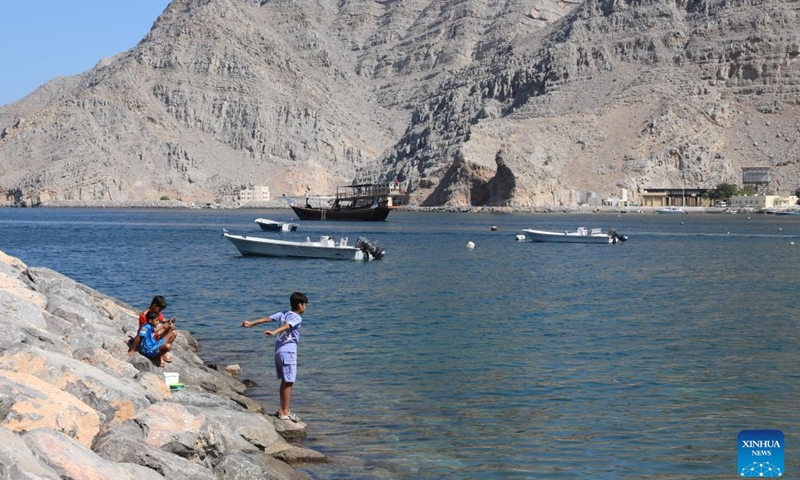 Children play by the shore at Kumzar Village in Oman, Feb. 19, 2025. Kumzar, a remote fishing village in the Musandam Peninsula in northern Oman, located in a sheltered harbor near the strategic shipping lane of the Strait of Hormuz. Due to its unique geographical location, Kumzar can only be accessed by boat, making it relatively isolated from the rest of Oman. This isolation has helped preserve its distinct cultural and linguistic identity. The residents of Kumzar primarily rely on fishing for their livelihood, maintaining a traditional maritime way of life. (Photo: Xinhua)