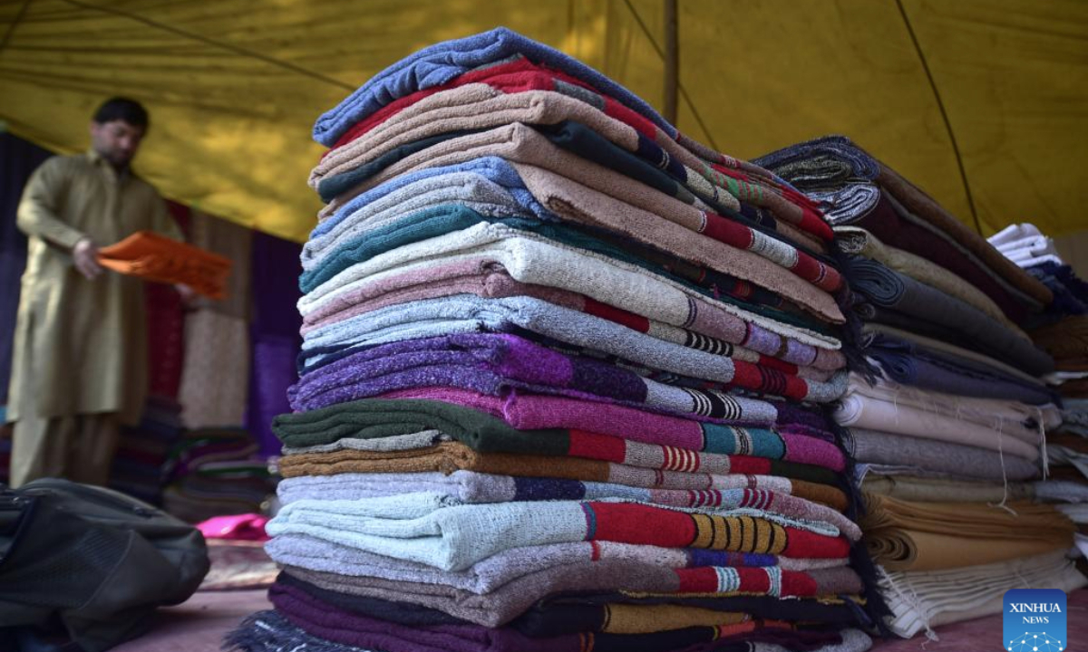 Colorful shawls are displayed at a local shop on the outskirts of northwest Pakistan's Peshawar on Feb. 26, 2025. (Photo by Saeed Ahmad/Xinhua)