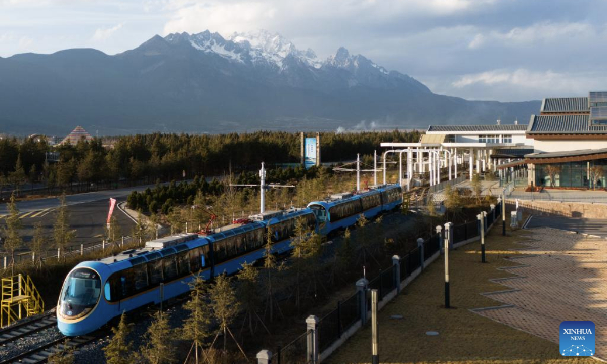 A drone photo shows a sightseeing train stopped at a tourists service center in southwest China's Yunnan Province, Feb. 25, 2025. A sightseeing train connecting Lijiang ancient town and Yulong Snow Mountain was launched here this February, becoming a new tourism hot spot in northwest Yunnan. (Photo by Peng Yikai/Xinhua)