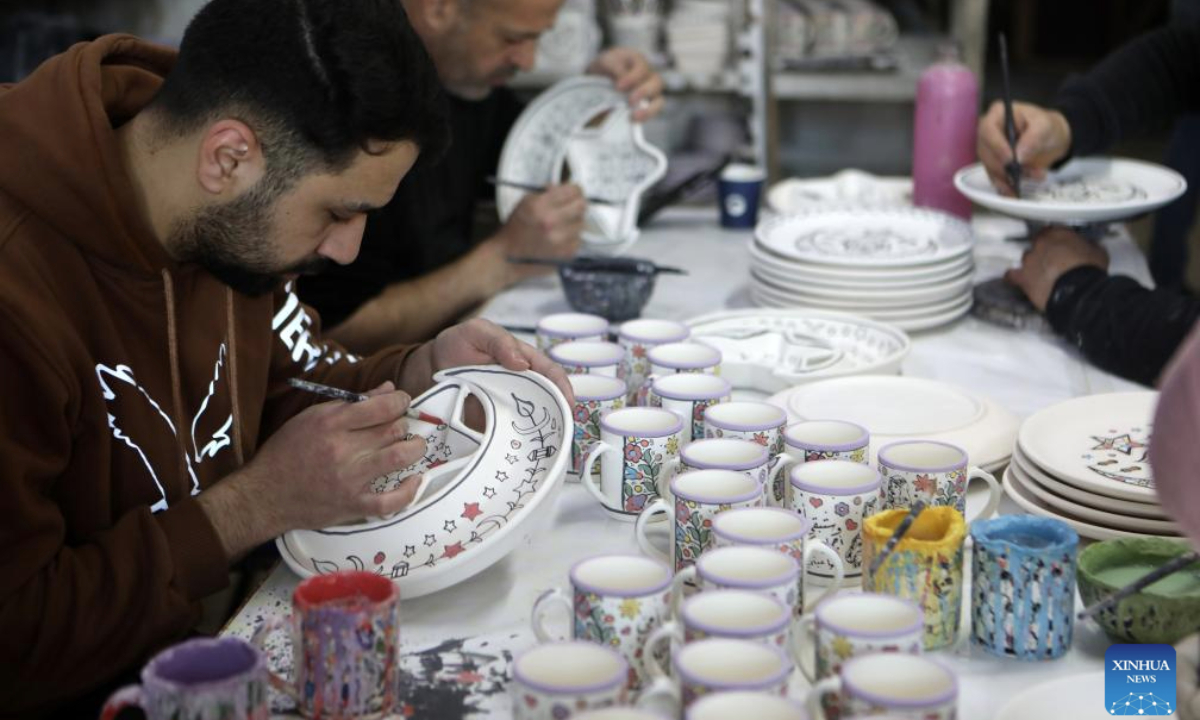 Palestinian workers make ceramic handicrafts at a shop in the West Bank city of Hebron, on Feb. 26, 2025. (Photo by Mamoun Wazwaz/Xinhua)
