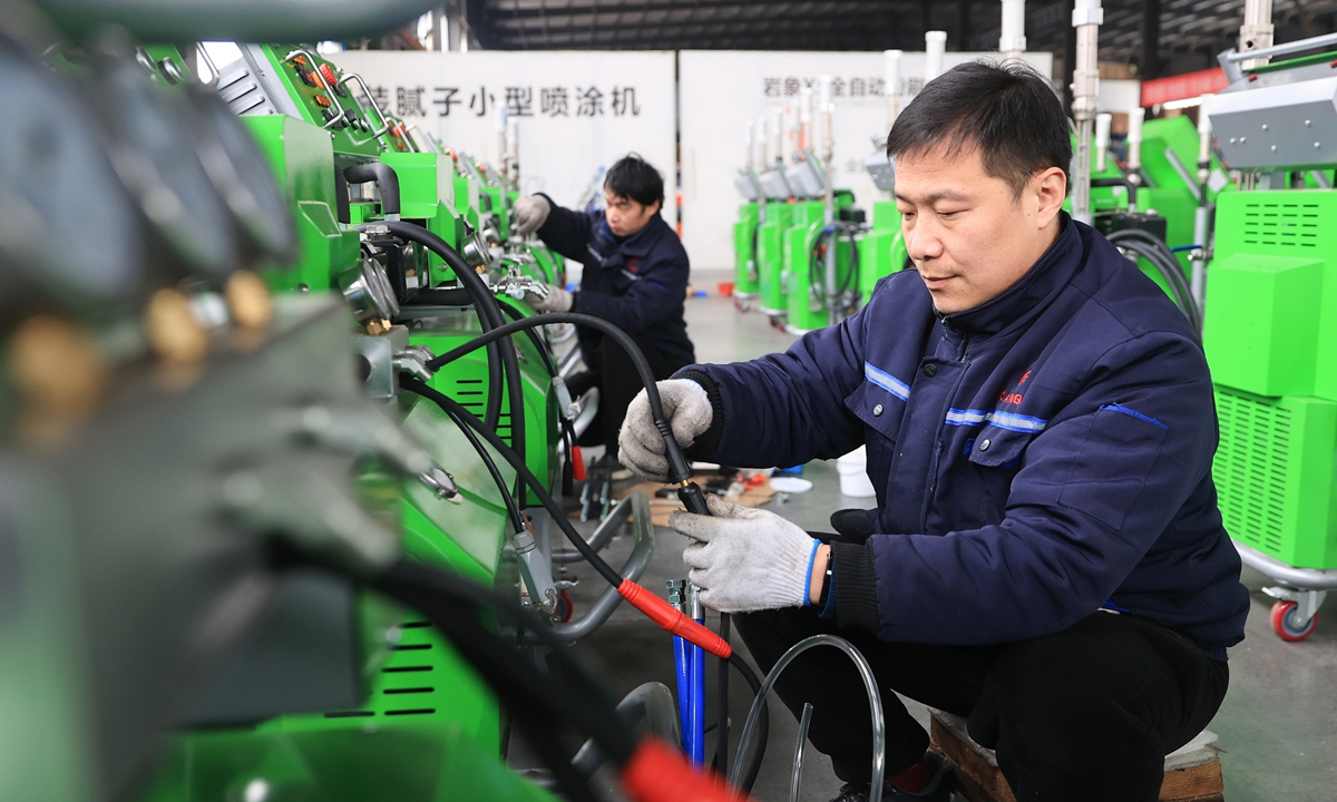 Workers assemble spray equipment for export orders  at an equipment company in Lianyungang, East China's Jiangsu Province on February 25, 2025. Statistics showed that China has become a major trading partner of more than 150 countries and regions in the world. Photo: VCG