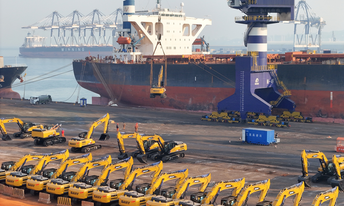 Excavators for export to Guinea are hoisted onto a cargo vessel of the China-Africa Shipping Line at Yantai Port, East China's Shandong Province on February 26, 2025. Photo: VCG