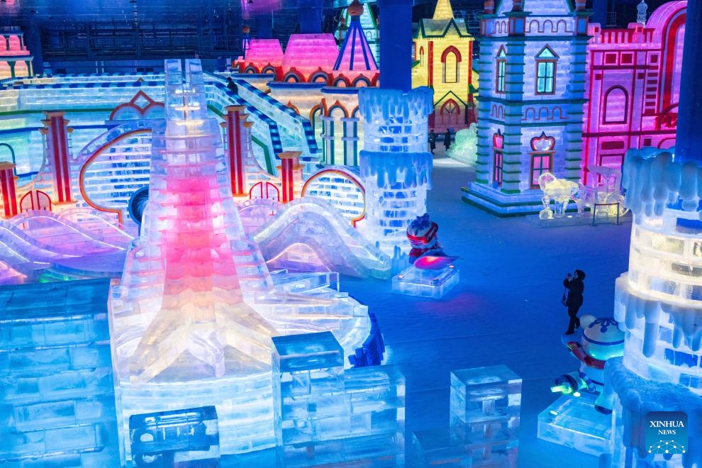 A visitor takes photos of the elaborate ice-and-snow landscapes at an indoor ice-and-snow theme park within Harbin Ice-Snow World in Harbin, northeast China's Heilongjiang Province, Feb. 27, 2025. The world's largest indoor ice-and-snow theme park, a facility located within Harbin Ice-Snow World, reopened on Thursday morning as the outdoor Harbin Ice-Snow World officially closed its 26th edition on Wednesday. Covering an area of 23,000 square meters, the indoor ice-and-snow attraction has seen a comprehensive refurbishment. (Photo: Xinhua)