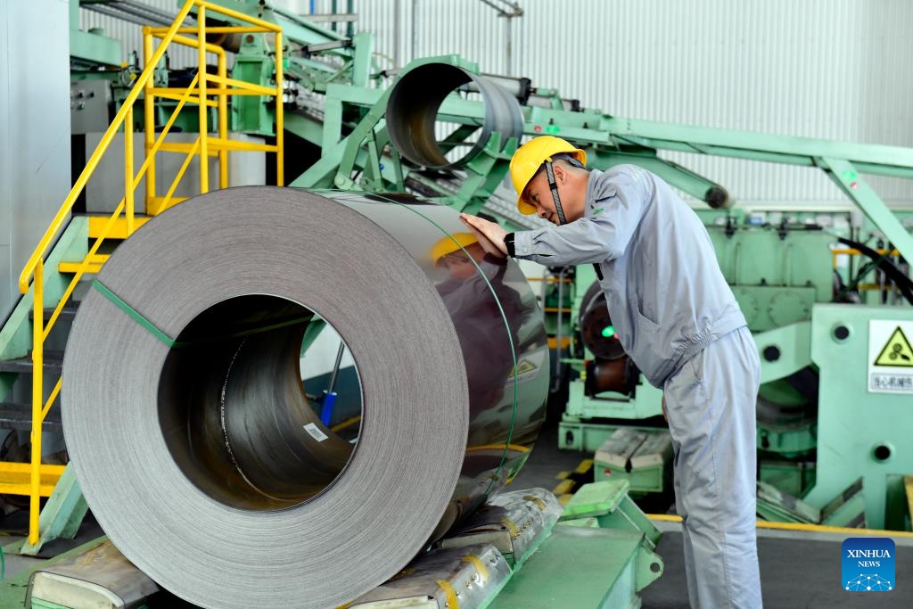 A worker checks color-coated steel plates at the workshop of Shandong Xinmeida Technology Materials Co. Ltd. in Binzhou, east China's Shandong Province, Feb. 26, 2025. Binzhou City is a major hub for private enterprises. In recent years, the city has fostered the development of private economy through comprehensive and end-to-end services. (Photo: Xinhua)
