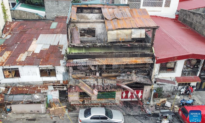 An aerial photo shows the site of a fire accident in Quezon City, the Philippines, Feb. 27, 2025. Eight people were killed after a fire razed a three-storey residential building in the Philippine capital on Thursday, the Bureau of Fire Protection said. The bureau said the fire broke out early Thursday morning in Quezon City suburb while the occupants were fast asleep. (Photo: Xinhua)