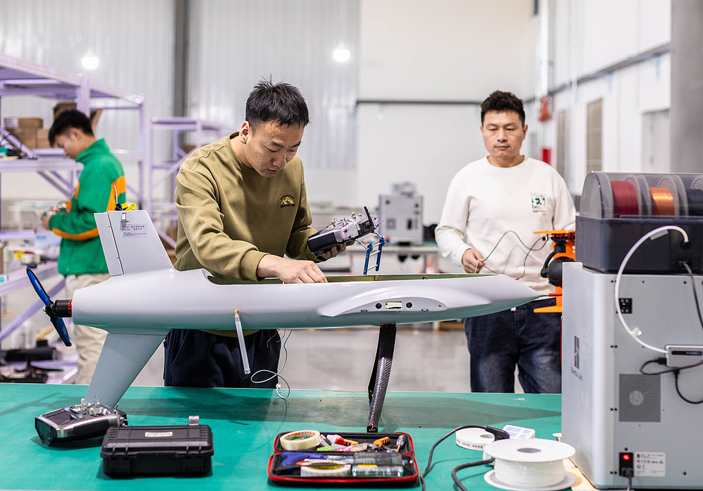 Technicians conduct installation and debugging on a vertical take-off and landing drone on February 28, 2025, in Hohhot, North China's Inner Mongolia Autonomous Region. This drone features an innovative aerodynamic configuration that combines connected wings with multi-rotors, and is designed for applications such as large-scale emergency aid and national land surveying. Photo: VCG