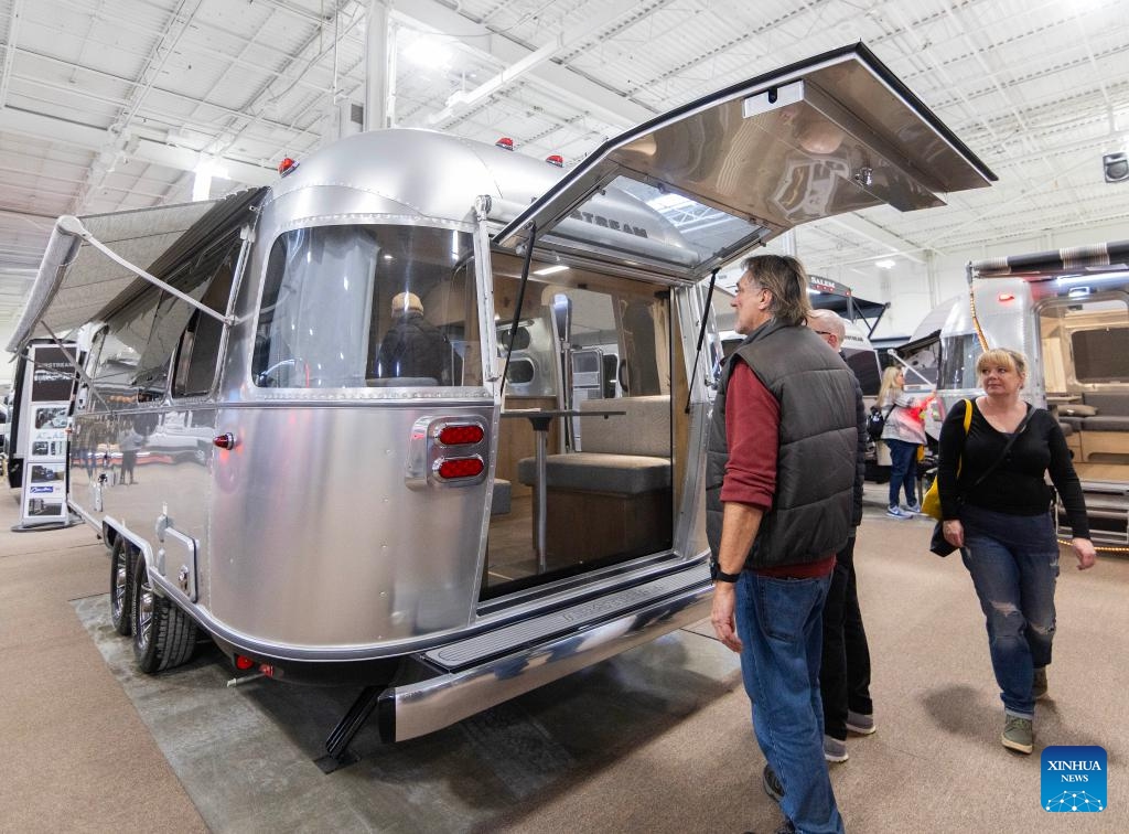 People look at a travel trailer during the 2025 Toronto Spring Camping and RV Show in Mississauga, the Greater Toronto Area, Canada, on Feb. 27, 2025. Showcasing more than 450 RVs, this annual show kicked off here on Thursday and will last until March 2. (Photo: Xinhua)