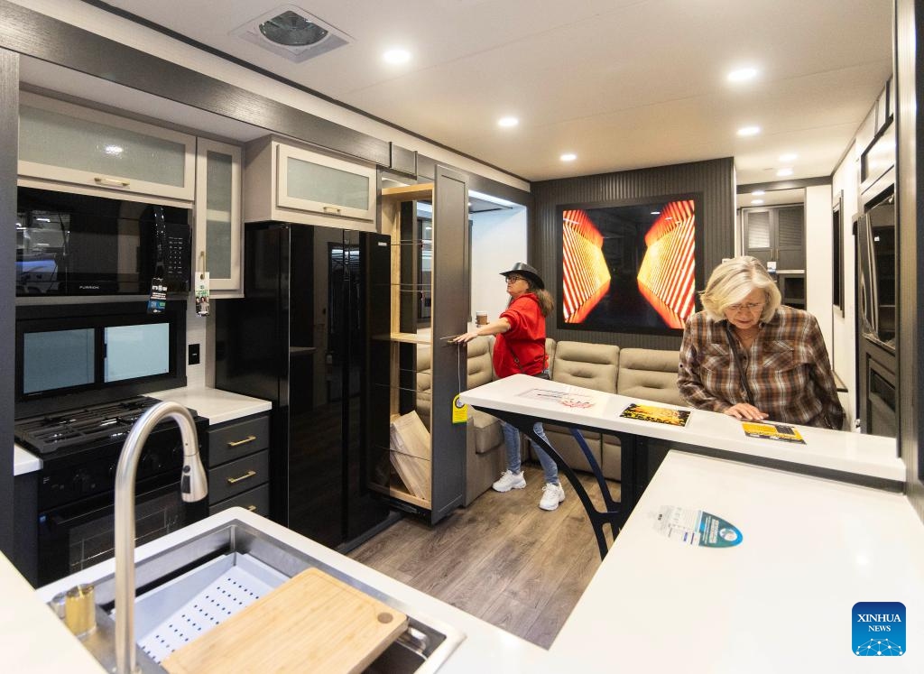 People tour a travel trailer during the 2025 Toronto Spring Camping and RV Show in Mississauga, the Greater Toronto Area, Canada, on Feb. 27, 2025. Showcasing more than 450 RVs, this annual show kicked off here on Thursday and will last until March 2. (Photo: Xinhua)