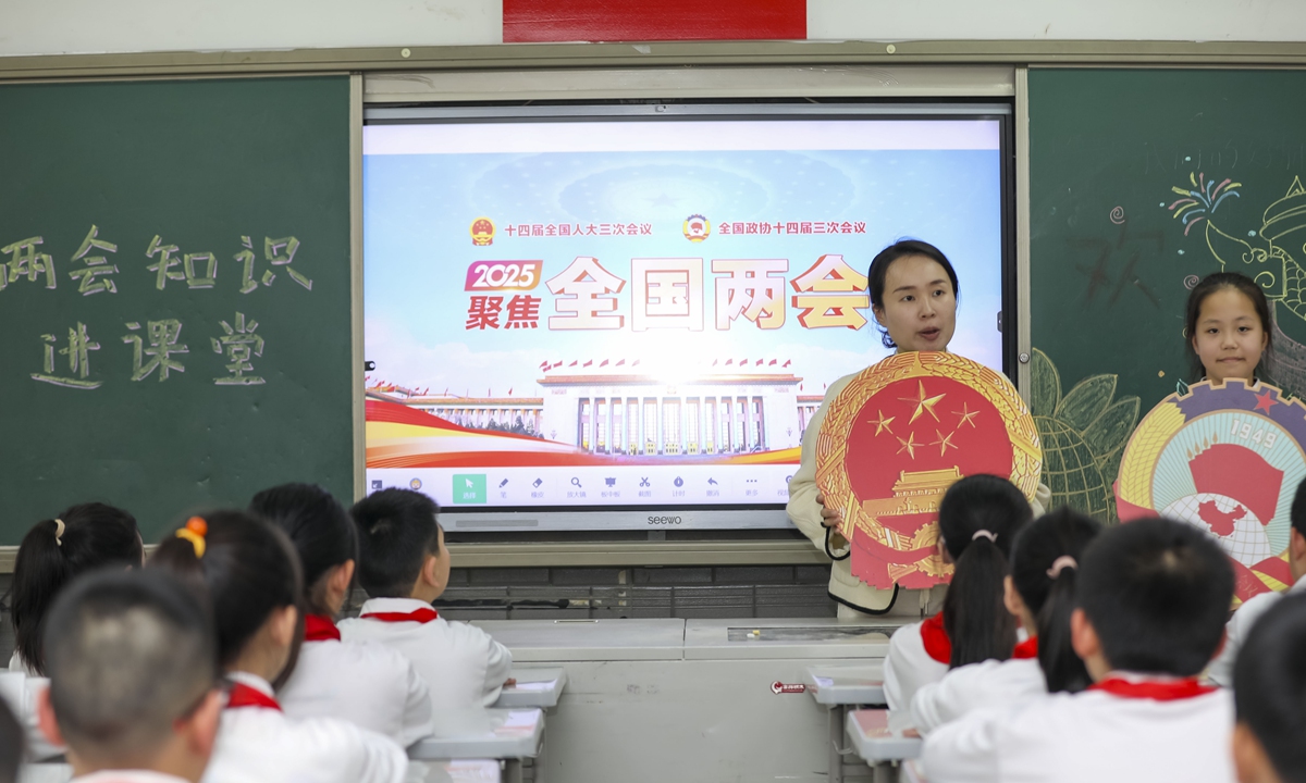 A teacher at the Dounan Elementary School in Fuzhou, East China's Fujian Province, holds a special class to educate students about the annual 