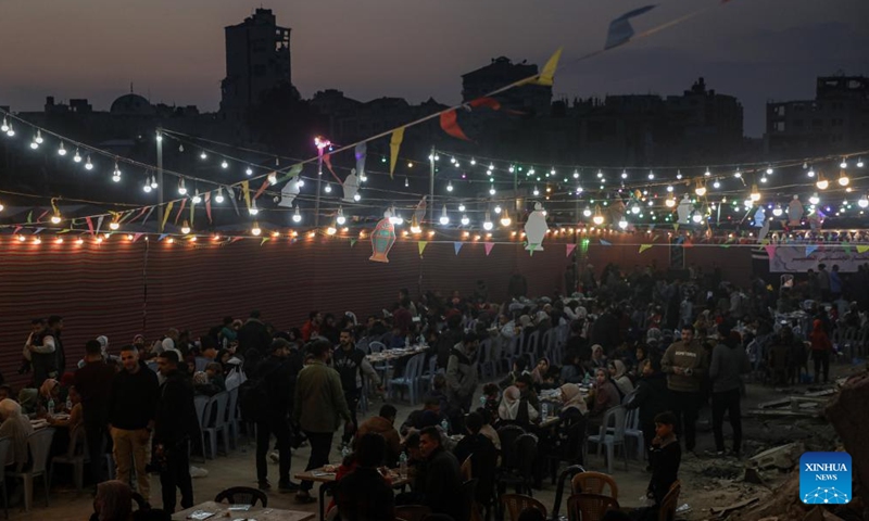 People gather for a group Ramadan iftar amid rubble of destroyed buildings in the north of Gaza City, on March 6, 2025. (Photo: Xinhua)