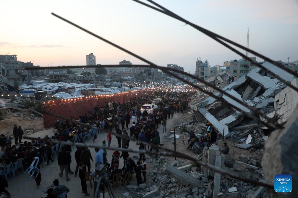 People gather for a group Ramadan iftar amid rubble of destroyed buildings in the north of Gaza City, on March 6, 2025. (Photo: Xinhua)