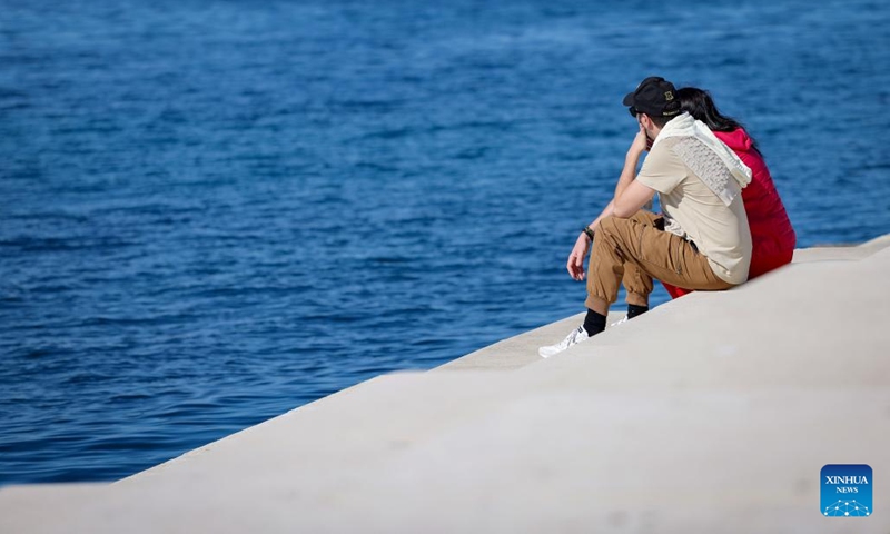 People spend time on the shore of the Adriatic Sea in Zadar, Croatia, on March 6, 2025. The highest temperature here reached 20 degrees Celsius on Thursday. (Photo: Xinhua)