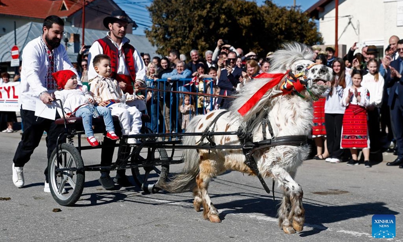 People ride their pony-driven cart for a caballine beauty contest during the celebration of the traditional Tudorita holiday, also known as the Easter of Horses, in Targoviste, Romania, March 8, 2025. Easter of Horses is celebrated by the local Bulgarian community and symbolizes the start of agricultural work in the new year. Photo: Xinhua
