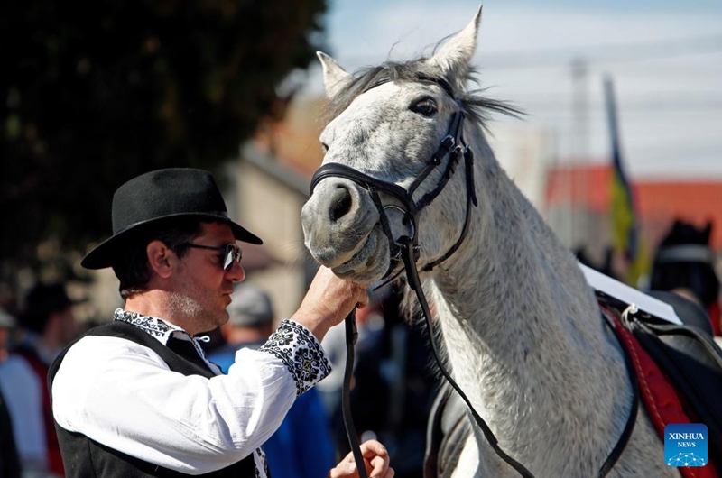 A man interacts with his horse during the celebration of the traditional Tudorita holiday, also known as the Easter of Horses, in Targoviste, Romania, March 8, 2025. Easter of Horses is celebrated by the local Bulgarian community and symbolizes the start of agricultural work in the new year. Photo: Xinhua