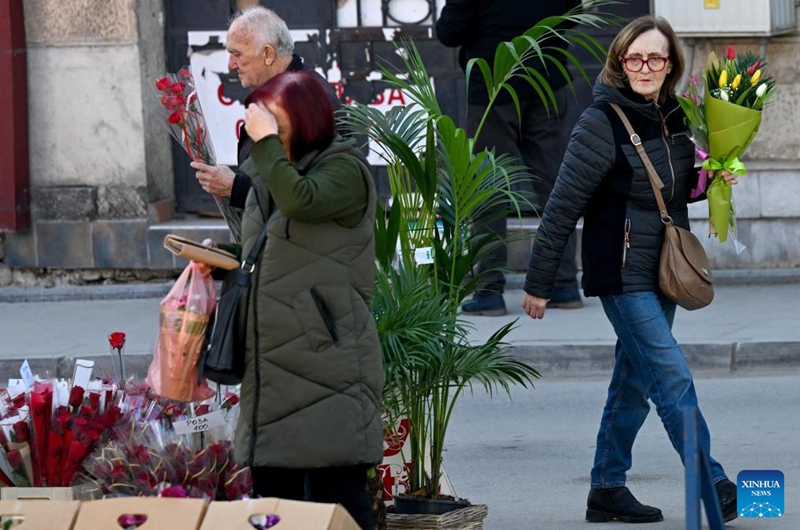 People holding flowers walk on a street in Bitola, North Macedonia, on the occasion of International Women's Day, March 8, 2025. Photo: Xinhua