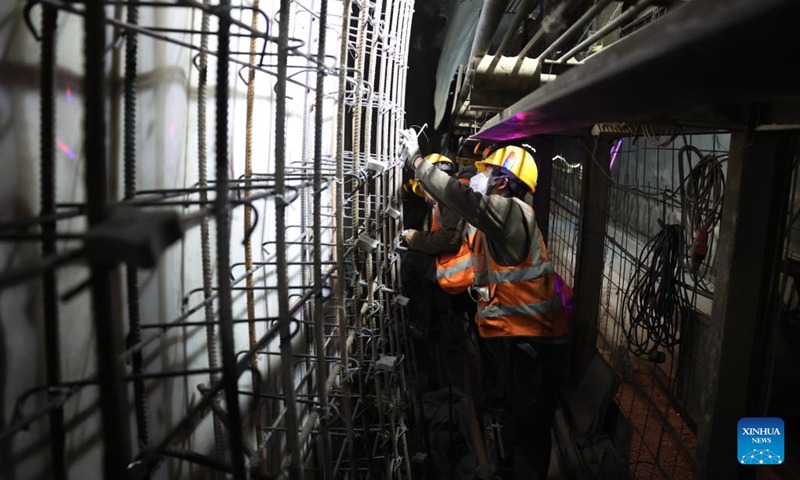 Staff members work on the construction site of the right track tunnel of the Huangjialing Tunnel in Linxia Hui Autonomous Prefecture, northwest China's Gansu Province, March 9, 2025. The right track tunnel of the Huangjialing Tunnel was drilled through on Sunday. The Huangjialing Tunnel, with a total length of 5,881 meters, is a key project of Lanzhou-Hezuo high-speed railway, a part of China's high-speed rail network that centers around eight main vertical lines linking the north and south and eight horizontal lines connecting the east and west. Photo: Xinhua