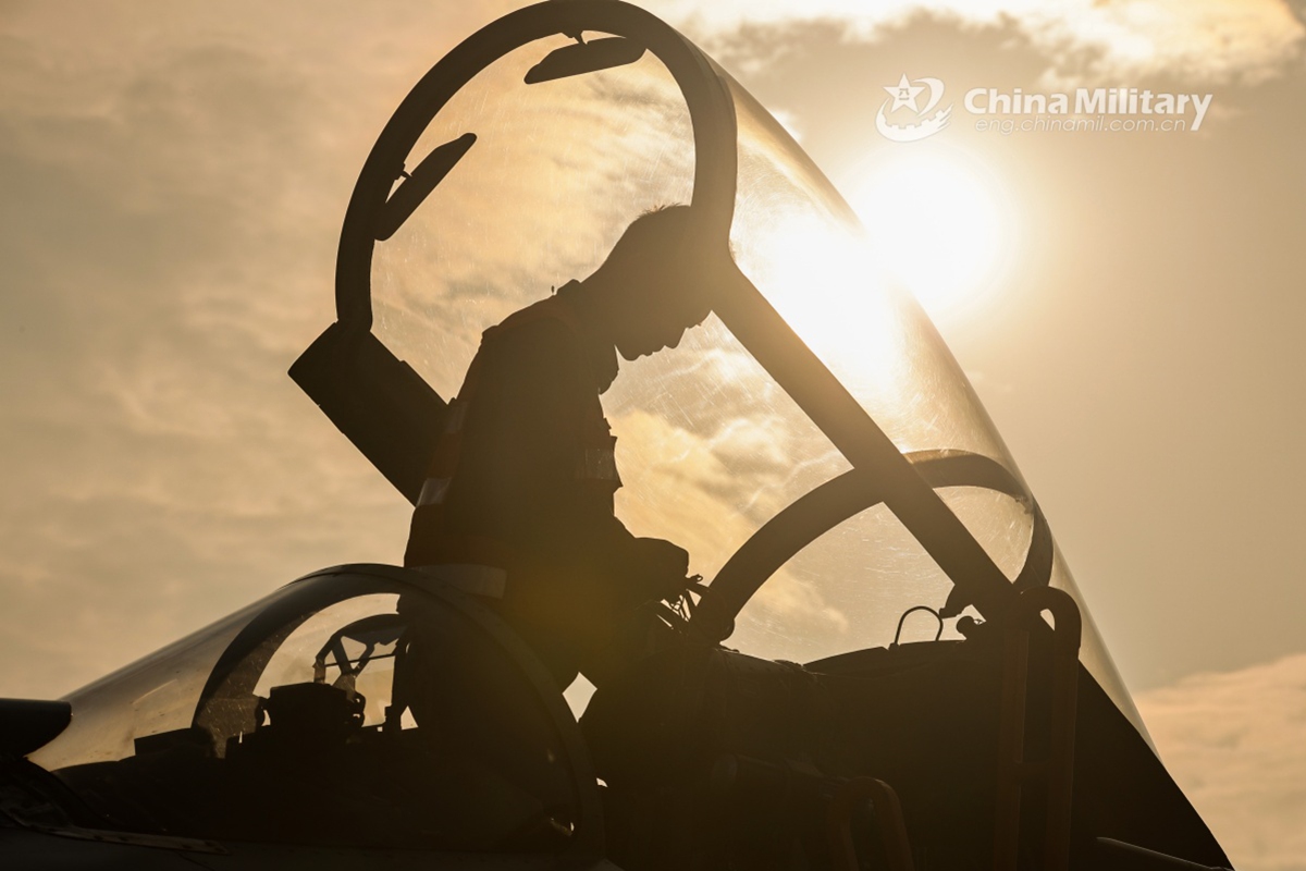 A pilot assigned to an aviation brigade with the air force under the Chinese PLA Southern Theater Command steps into the cockpit of his fighter jet and performs pre-flight inspections during a flight training exercise on February 20, 2025. (eng.chinamil.com.cn/Photo by Li Chengshen)
