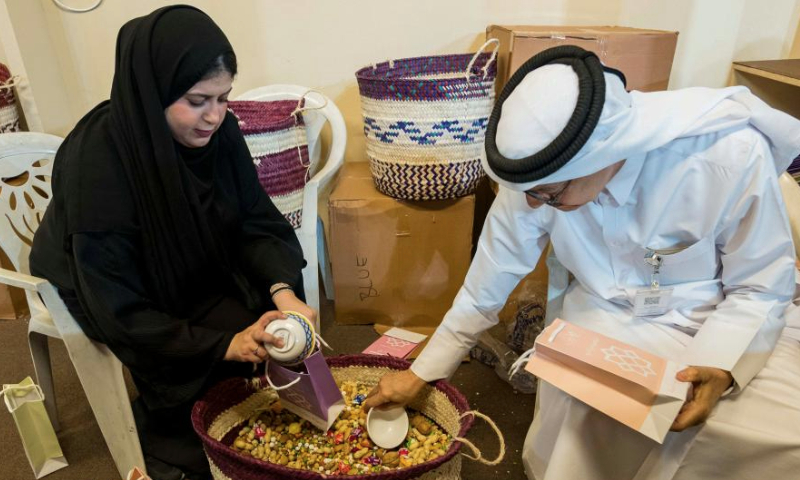 Volunteers prepare gift packages for children during the Garangao festival at Souq Waqif in Doha, capital of Qatar, March 14, 2025. The Garangao festival is mainly celebrated in the Gulf countries after sunset prayer on the 14th day of the holy fasting month of Ramadan. (Photo by Nikku/Xinhua)