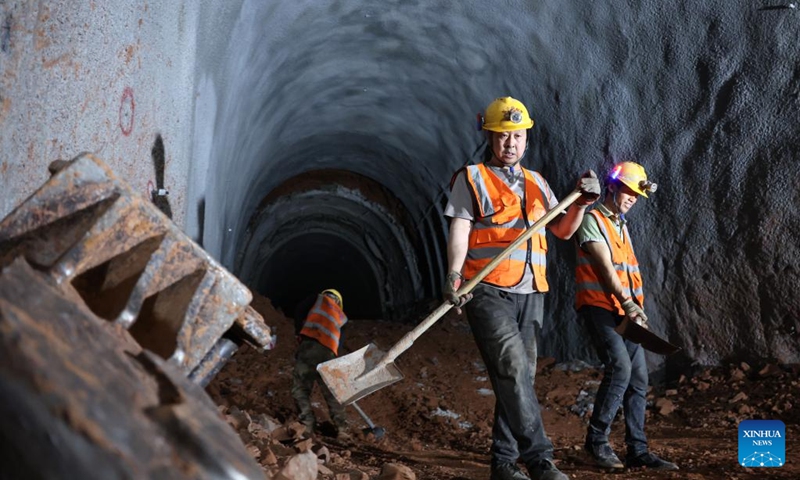 Staff members work on the construction site of the right track tunnel of the Huangjialing Tunnel in Linxia Hui Autonomous Prefecture, northwest China's Gansu Province, March 9, 2025. The right track tunnel of the Huangjialing Tunnel was drilled through on Sunday. The Huangjialing Tunnel, with a total length of 5,881 meters, is a key project of Lanzhou-Hezuo high-speed railway, a part of China's high-speed rail network that centers around eight main vertical lines linking the north and south and eight horizontal lines connecting the east and west. Photo: Xinhua