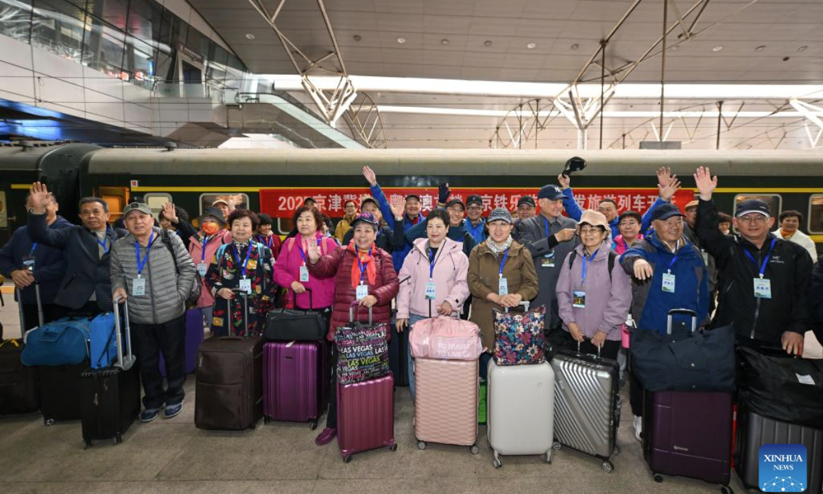 Passengers pose for a group photo before boarding a tourist train for seniors at Tianjin Railway Station in Tianjin, north China, March 15, 2025. A tourist train for seniors departed from north China's Tianjin on Saturday. Carrying a total of 452 silver-haired passengers from the Beijing-Tianjin-Hebei region, the train is on a 12-day journey and will visit a series of tourist areas in Jiangxi, Hunan and Guangdong provinces. (Xinhua/Sun Fanyue)