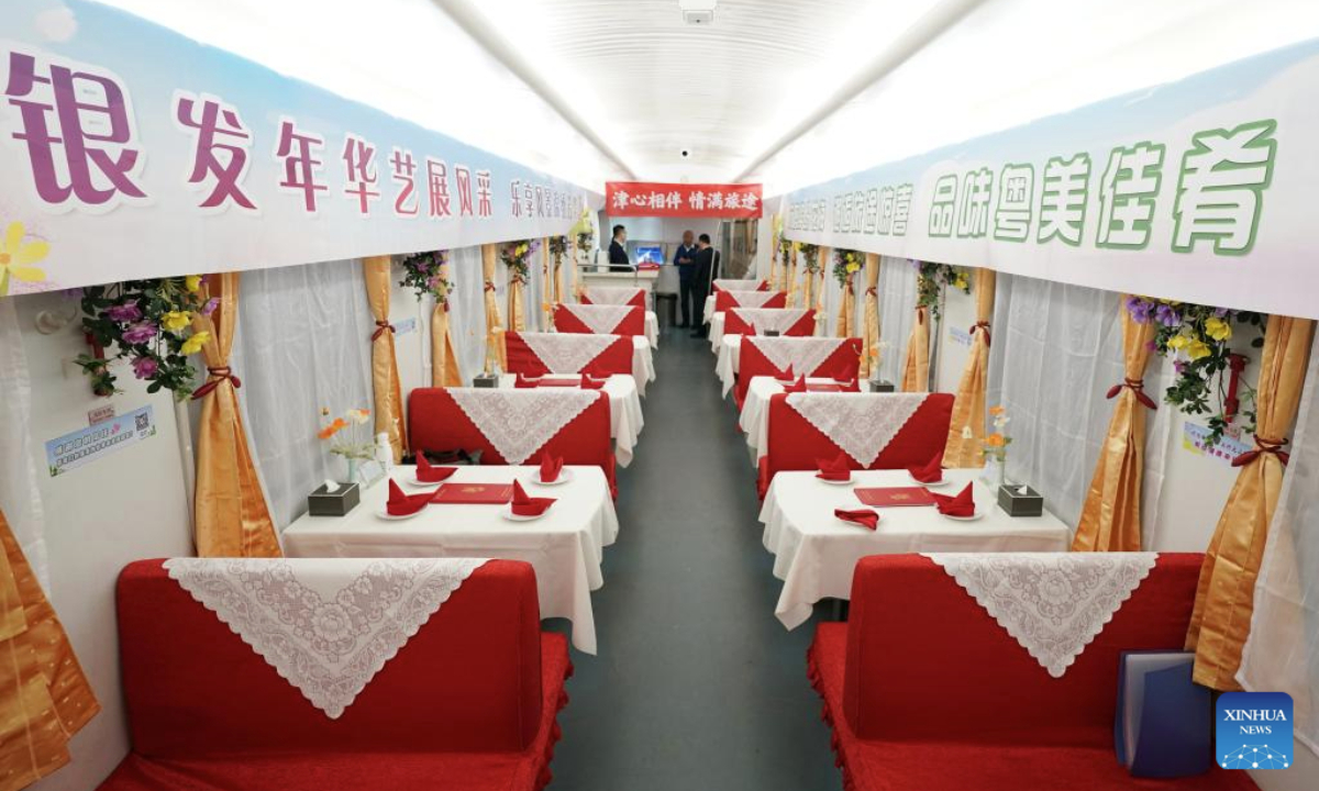A dining car of a tourist train for seniors is pictured in Beijing, capital of China, March 15, 2025. A tourist train for seniors departed from north China's Tianjin on Saturday. Carrying a total of 452 silver-haired passengers from the Beijing-Tianjin-Hebei region, the train is on a 12-day journey and will visit a series of tourist areas in Jiangxi, Hunan and Guangdong provinces. (Xinhua/Zhang Chenlin)