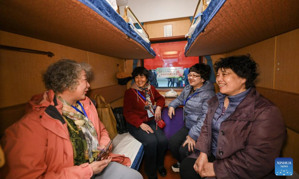 Passengers are pictured on a tourist train for seniors in Tianjin, north China, March 15, 2025. A tourist train for seniors departed from north China's Tianjin on Saturday. Carrying a total of 452 silver-haired passengers from the Beijing-Tianjin-Hebei region, the train is on a 12-day journey and will visit a series of tourist areas in Jiangxi, Hunan and Guangdong provinces. (Xinhua/Sun Fanyue)