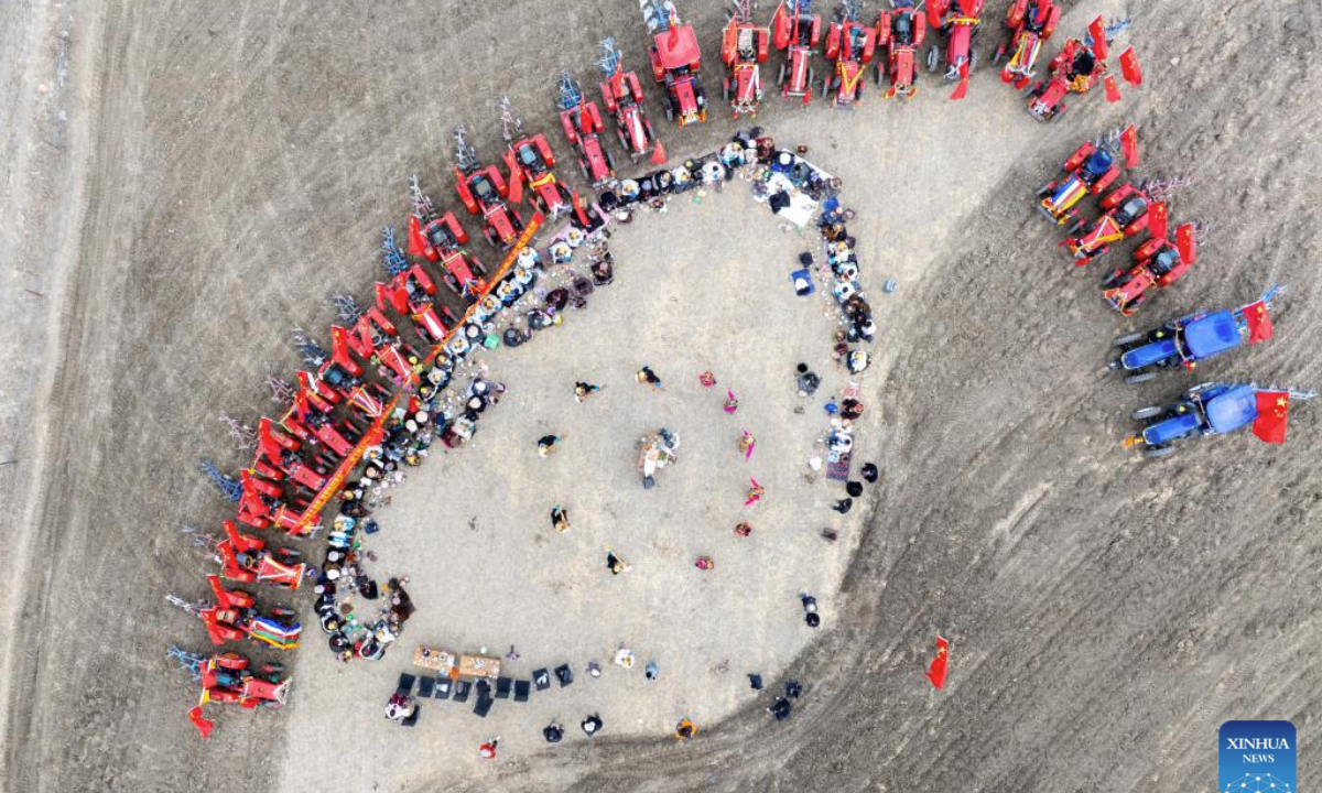 An aerial drone photo taken on March 16, 2025 shows a ceremony marking the start of spring farming in Quxar Town of Lnaze County, southwest China's Xizang Autonomous Region. Ceremonies marking the start of spring farming were held across Xizang on Sunday. The ceremony holds great significance as it marks the beginning of a new year's farming season and serves as a prayer for favorable weather and bountiful harvests. It is considered an important ritual in the farming regions of Xizang. (Xinhua/Jiang Fan)