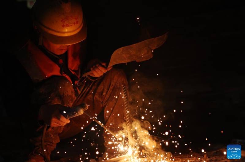 A staff member works on the construction site of the right track tunnel of the Huangjialing Tunnel in Linxia Hui Autonomous Prefecture, northwest China's Gansu Province, March 9, 2025. The right track tunnel of the Huangjialing Tunnel was drilled through on Sunday. The Huangjialing Tunnel, with a total length of 5,881 meters, is a key project of Lanzhou-Hezuo high-speed railway, a part of China's high-speed rail network that centers around eight main vertical lines linking the north and south and eight horizontal lines connecting the east and west. Photo: Xinhua