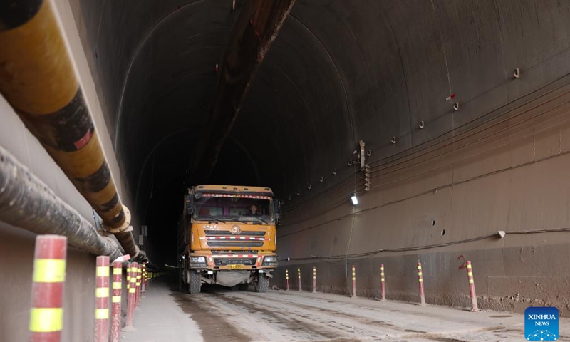 A staff member drives out of the right track tunnel of the Huangjialing Tunnel in Linxia Hui Autonomous Prefecture, northwest China's Gansu Province, March 9, 2025. The right track tunnel of the Huangjialing Tunnel was drilled through on Sunday. The Huangjialing Tunnel, with a total length of 5,881 meters, is a key project of Lanzhou-Hezuo high-speed railway, a part of China's high-speed rail network that centers around eight main vertical lines linking the north and south and eight horizontal lines connecting the east and west. (Photo: Xinhua)