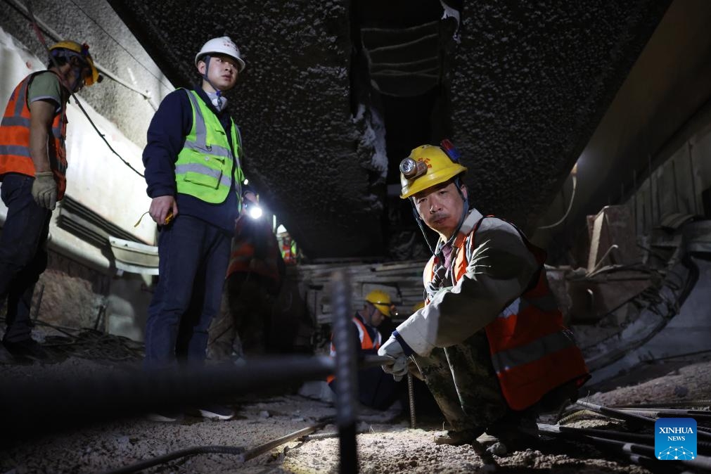 Staff members work on the construction site of the right track tunnel of the Huangjialing Tunnel in Linxia Hui Autonomous Prefecture, northwest China's Gansu Province, March 9, 2025. The right track tunnel of the Huangjialing Tunnel was drilled through on Sunday. The Huangjialing Tunnel, with a total length of 5,881 meters, is a key project of Lanzhou-Hezuo high-speed railway, a part of China's high-speed rail network that centers around eight main vertical lines linking the north and south and eight horizontal lines connecting the east and west. (Photo: Xinhua)