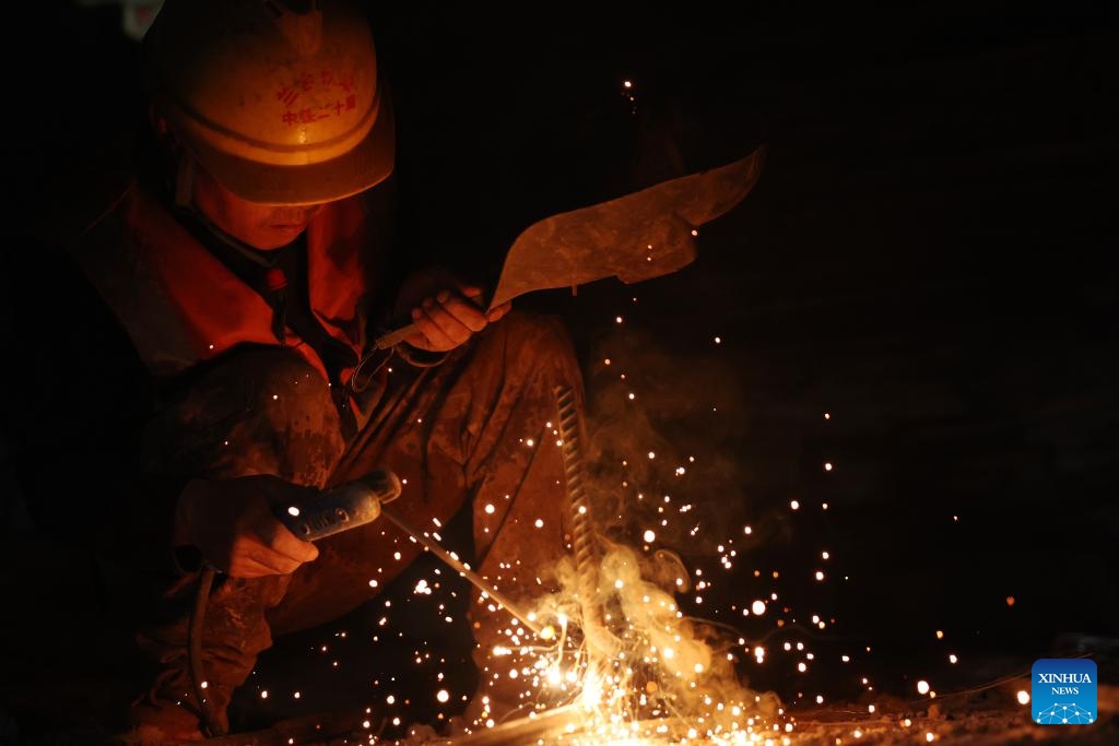 A staff member works on the construction site of the right track tunnel of the Huangjialing Tunnel in Linxia Hui Autonomous Prefecture, northwest China's Gansu Province, March 9, 2025. The right track tunnel of the Huangjialing Tunnel was drilled through on Sunday. The Huangjialing Tunnel, with a total length of 5,881 meters, is a key project of Lanzhou-Hezuo high-speed railway, a part of China's high-speed rail network that centers around eight main vertical lines linking the north and south and eight horizontal lines connecting the east and west. (Photo: Xinhua)