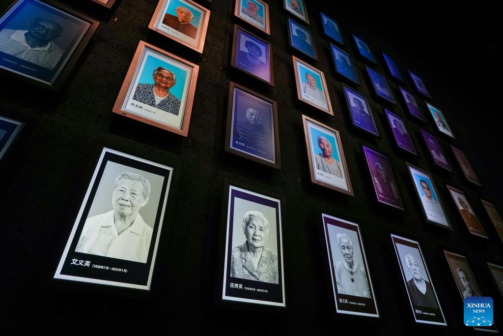 Light boxes of Nanjing Massacre survivors Ai Yiying, Wu Xiuying, Yi Lanying and Tao Chengyi (L-R in the bottom row), who passed away this year, are seen on the photo wall at the Memorial Hall of the Victims in Nanjing Massacre by Japanese Invaders, in Nanjing, east China's Jiangsu Province, March 11, 2025. A lights out mourning ceremony for four survivors of the Nanjing Massacre who passed away this year was held Tuesday in Nanjing. (Photo: Xinhua)