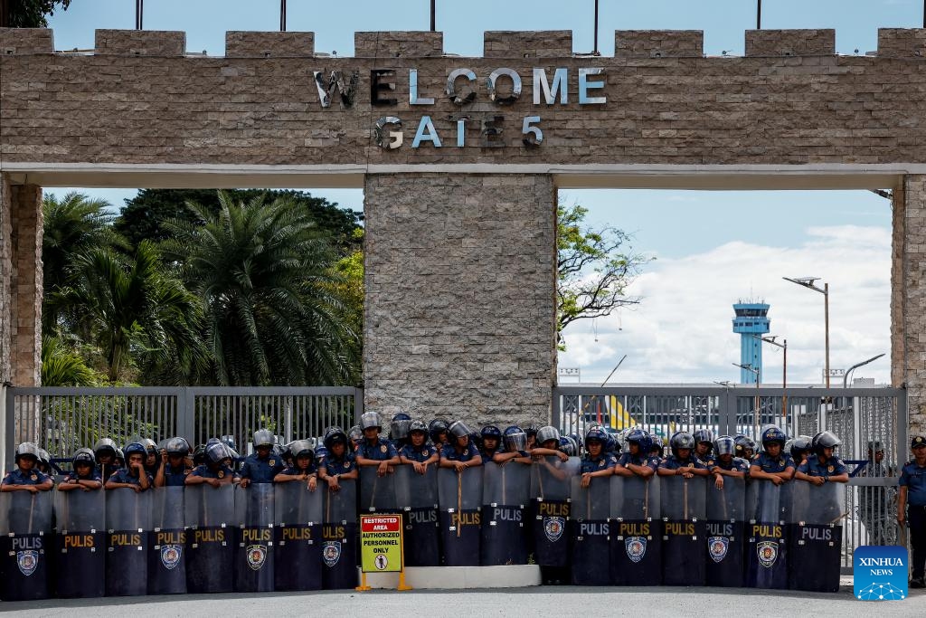 Policemen gather to secure the area where former Philippine President Rodrigo Duterte is being held in the Villamor Airbase in Pasay City, Metro Manila, the Philippines, March 11, 2025. The Philippine Presidential Communications Office (PCO) issued a statement on Tuesday, confirming that former President Rodrigo Duterte was detained by police upon his return to Manila from abroad. (Photo: Xinhua)
